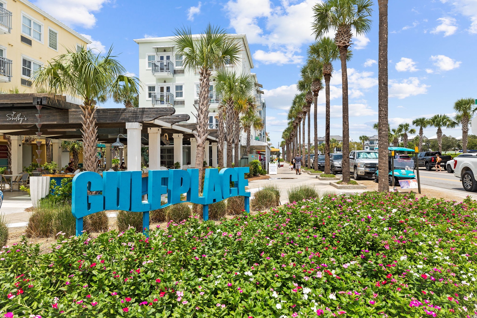 Gulf Place town center features palm-lined streets, restaurants, and shops in this vibrant coastal community.