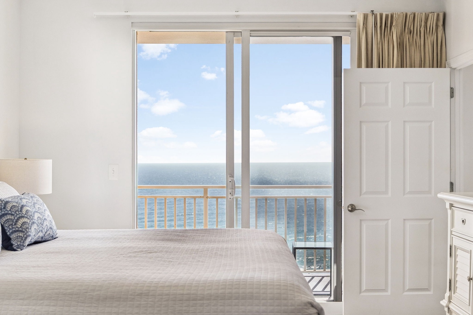 Wake up to breathtaking ocean views from your oceanfront bedroom, where gentle sea breezes flow through your private balcony doors.