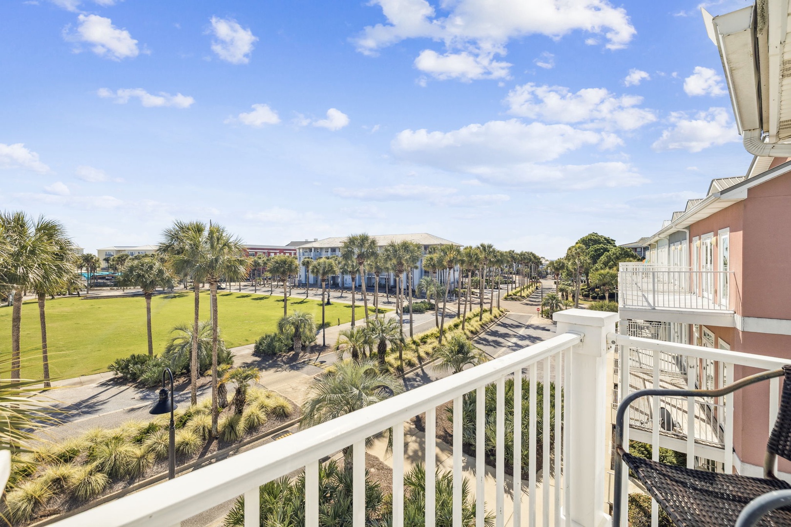 Enjoy panoramic views of palm-lined walkways and lush green spaces from your private balcony, where peaceful mornings await with tropical breezes.