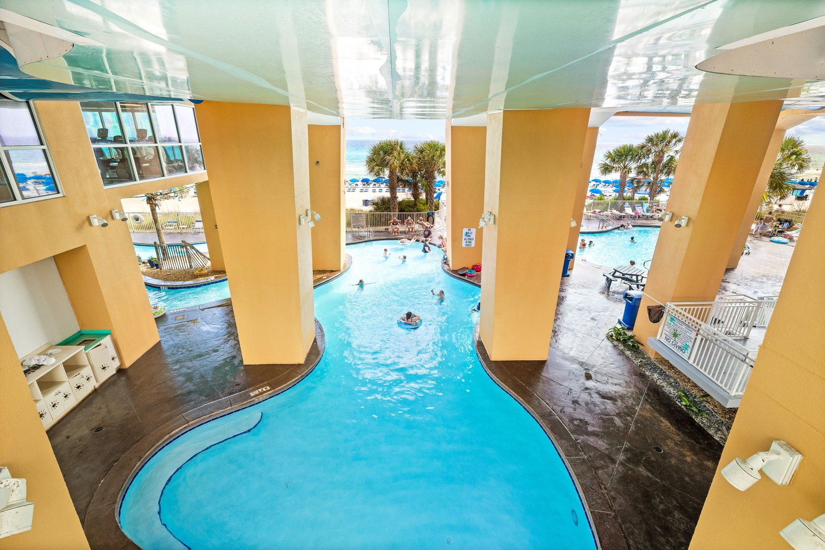 Dive into your tropical oasis featuring a stunning lazy river that winds through the property, with the beach just steps away.