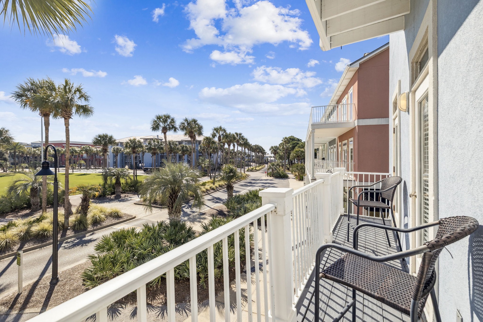 Step onto your private balcony and soak in the tropical paradise with swaying palms and resort amenities spread below.