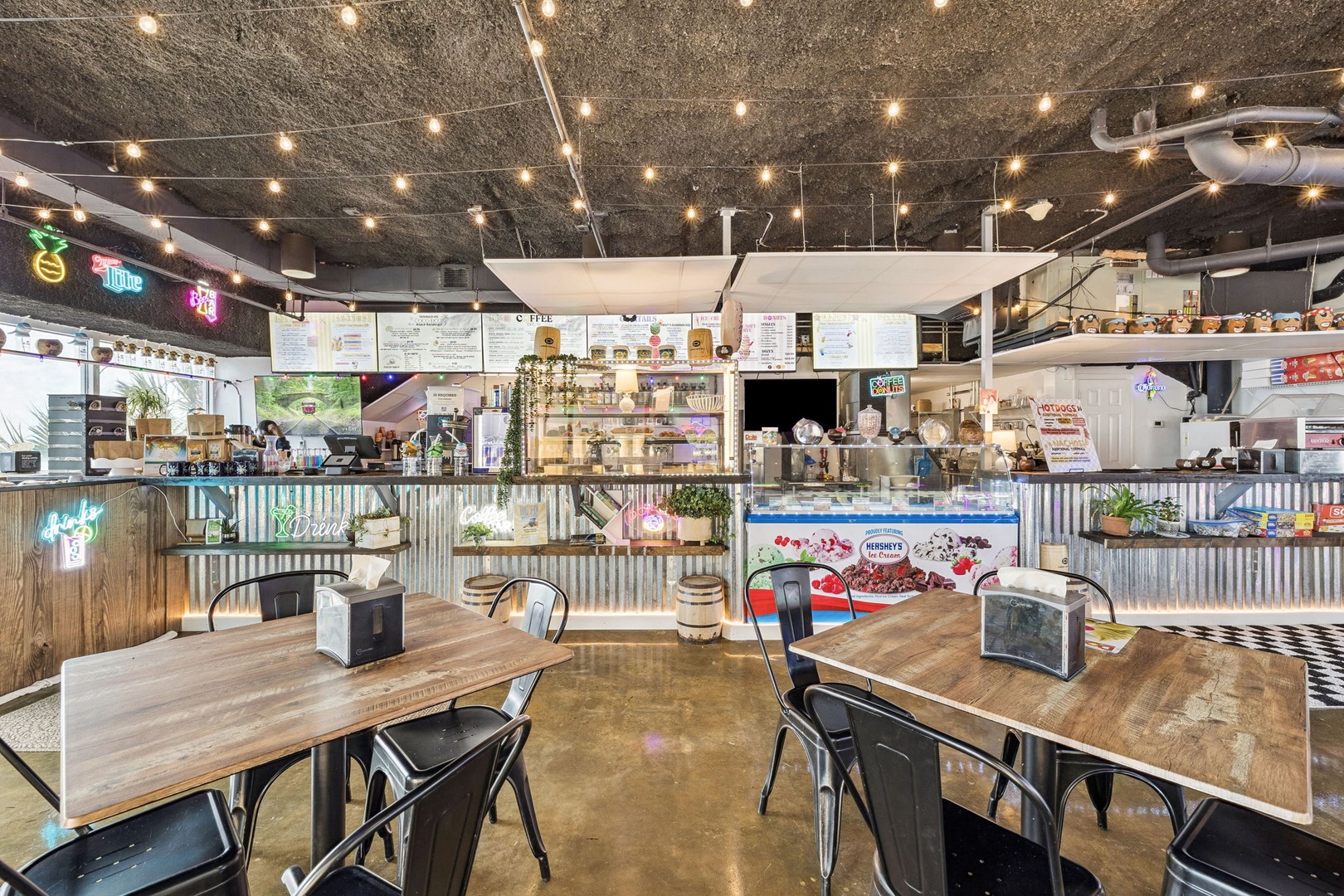 Step into this vibrant industrial-style café where string lights create a warm glow above your dining table.