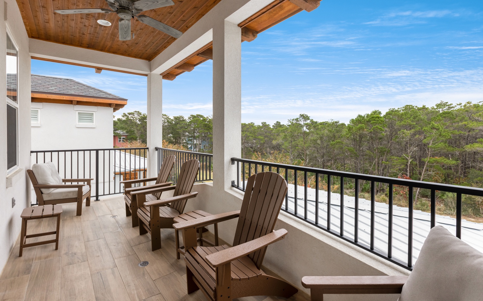 Unwind on your private balcony with comfortable seating and peaceful forest views stretching to the horizon.
