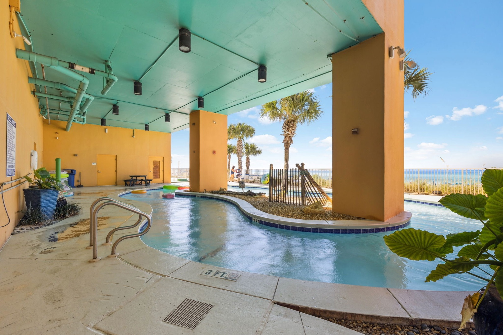 Dive into crystal-clear waters while overlooking stunning beachfront views from this covered pool oasis.