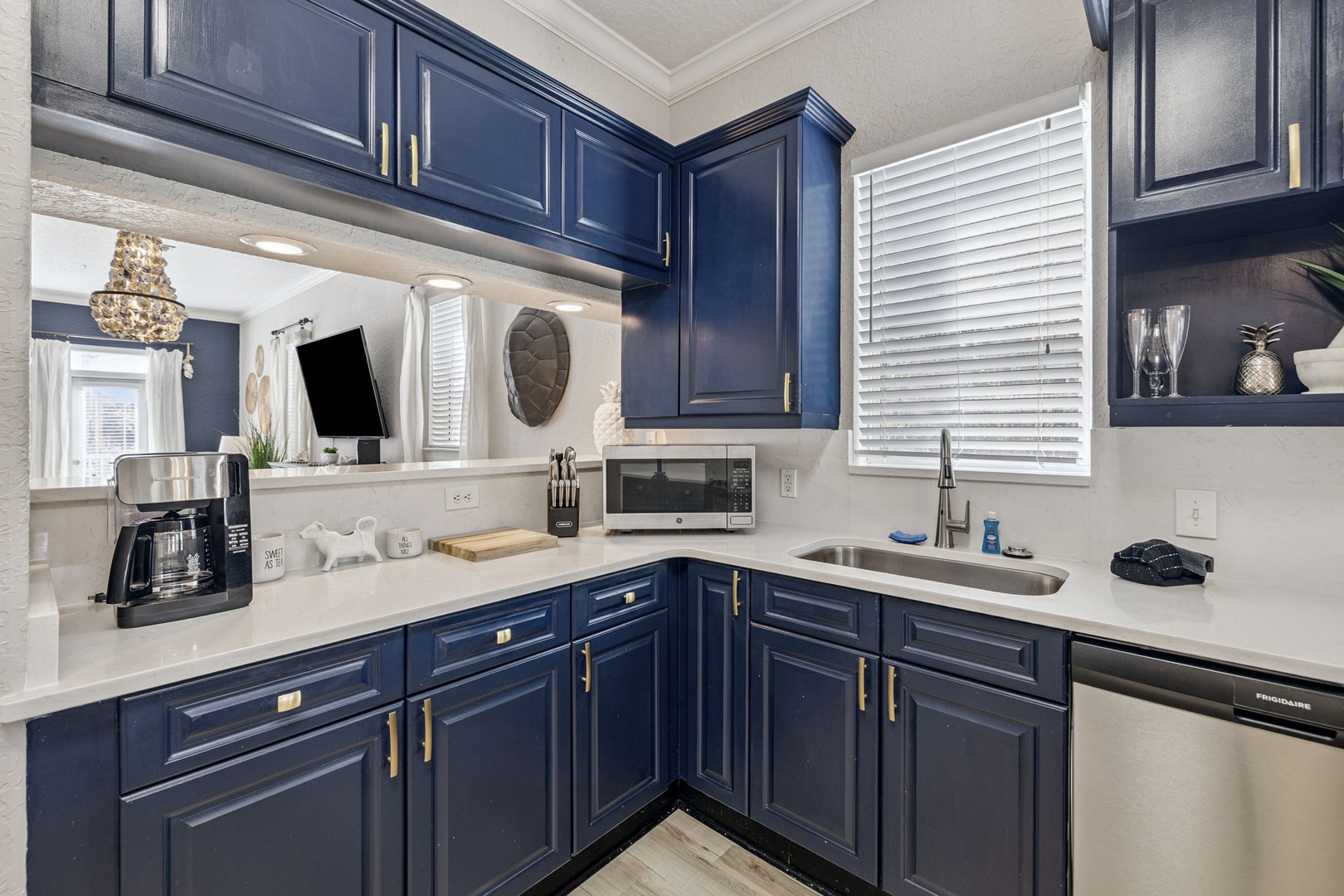 Your stylish kitchen features rich navy cabinets, pristine countertops, and everything you need to create memorable meals during your stay.