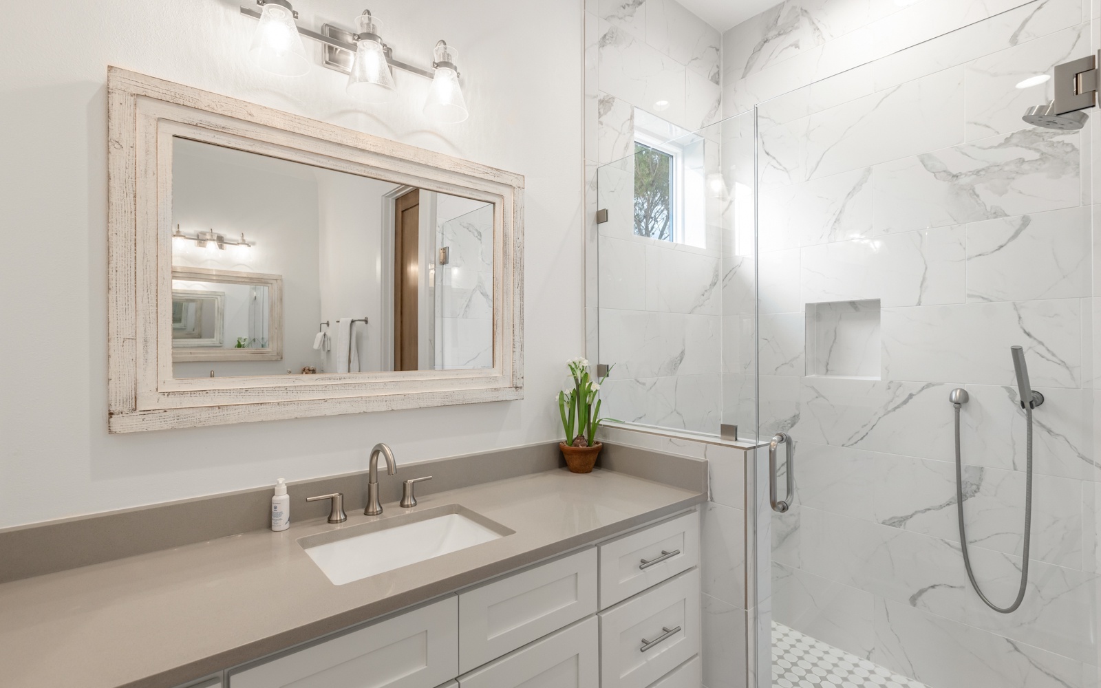 Step into your luxurious marble-wrapped bathroom with elegant vanity, walk-in shower, and pristine finishes that create a spa-like retreat.