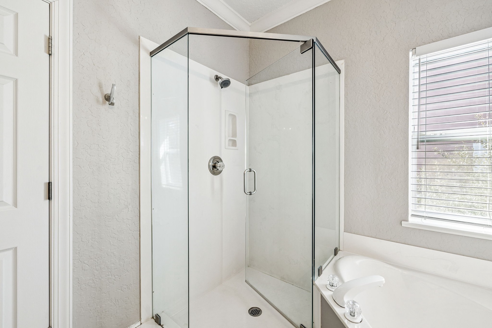Step into your spa-like glass shower with modern fixtures and sleek design for a refreshing start to each day.