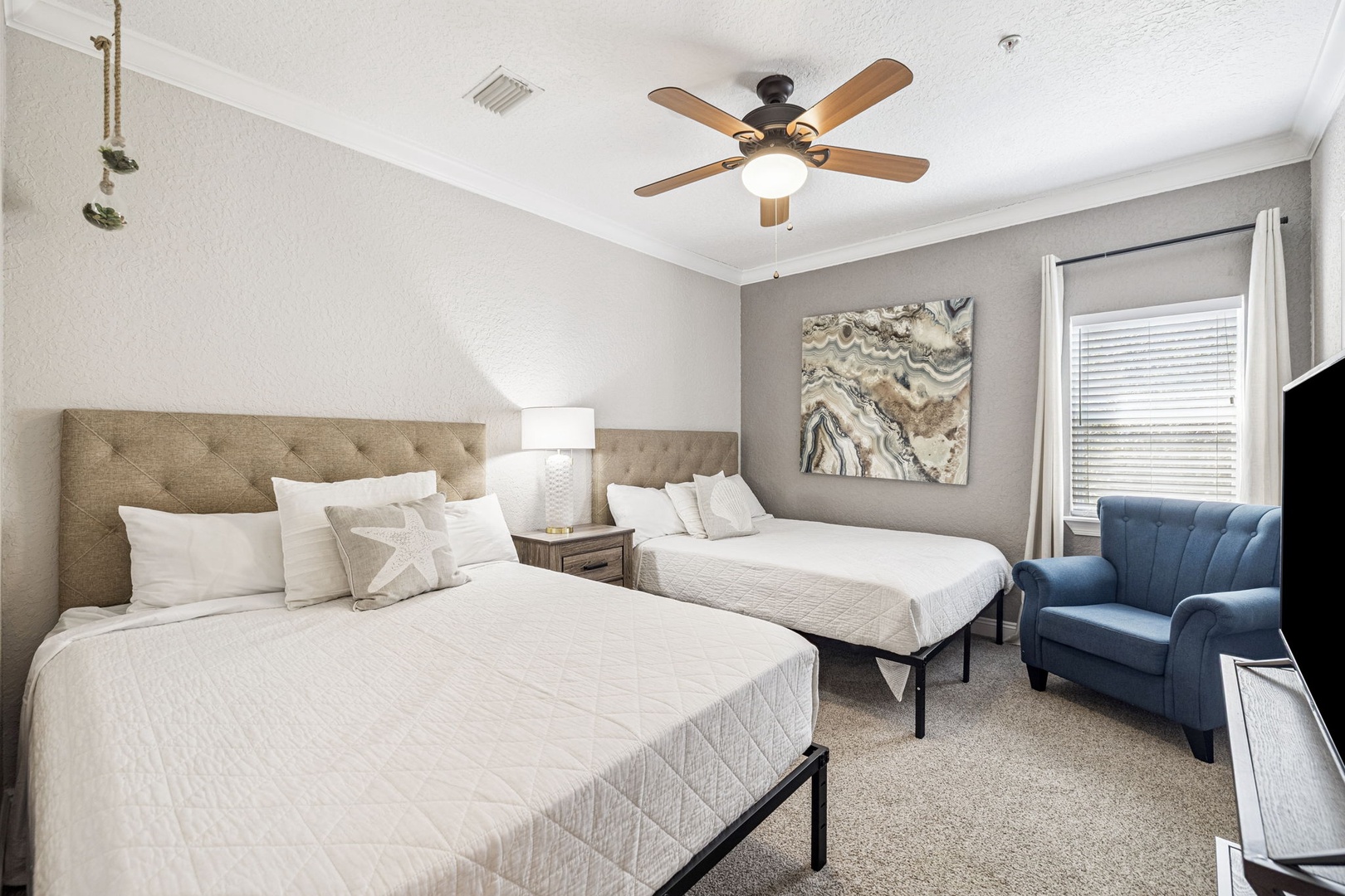 Sleep soundly in your comfortable twin bedroom with cozy seating, ceiling fan for perfect temperature, and calming neutral tones throughout.