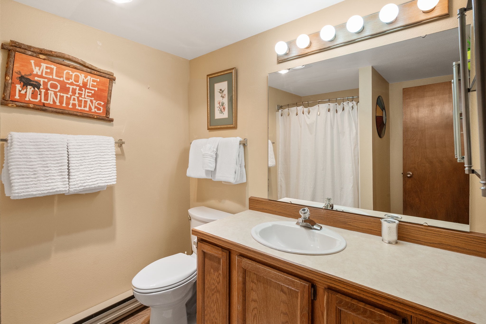Freshen up in your welcoming bathroom with warm mountain charm and all the essentials for your comfort.