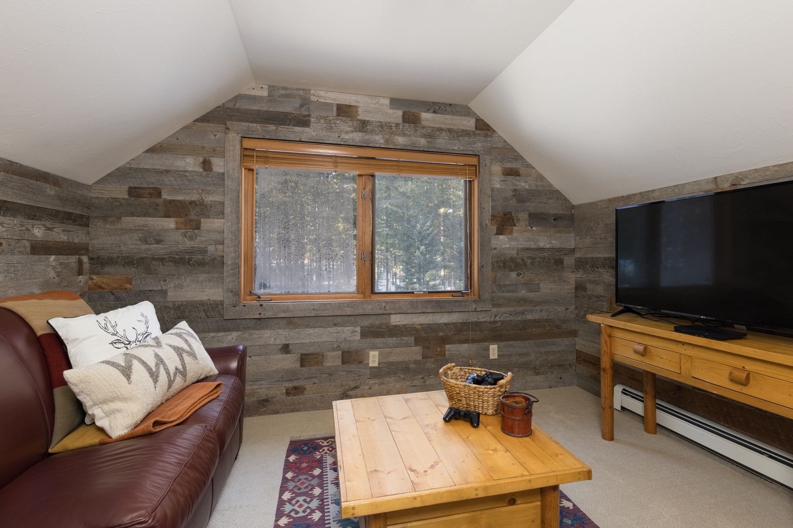 Cozy up in your rustic retreat with weathered wood walls and forest views outside your window.