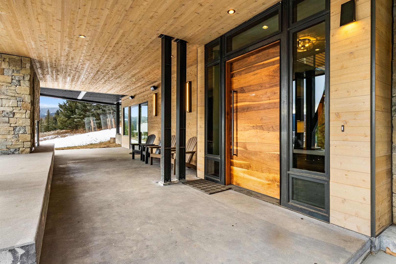 Step onto your private covered terrace where mountain views and modern alpine design create the perfect retreat for morning coffee or evening relaxation.