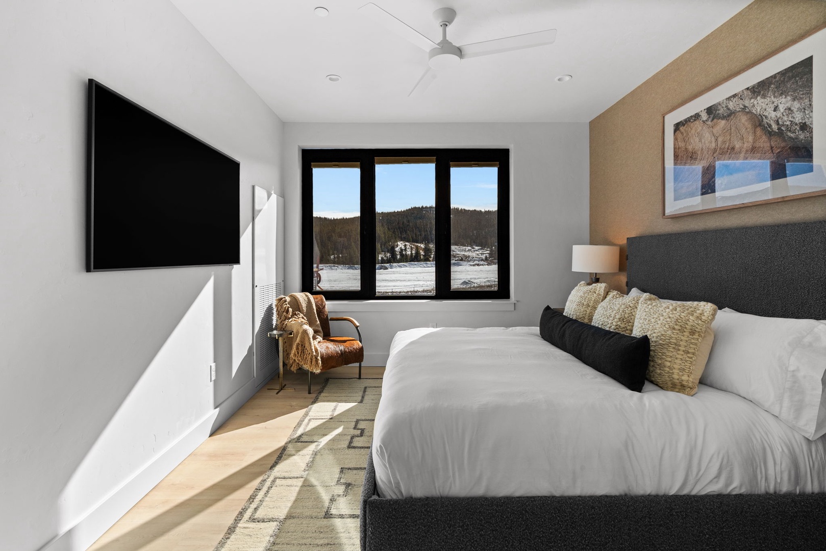 Cozy up in your serene retreat with stunning mountain views right from your bed, complete with modern amenities.