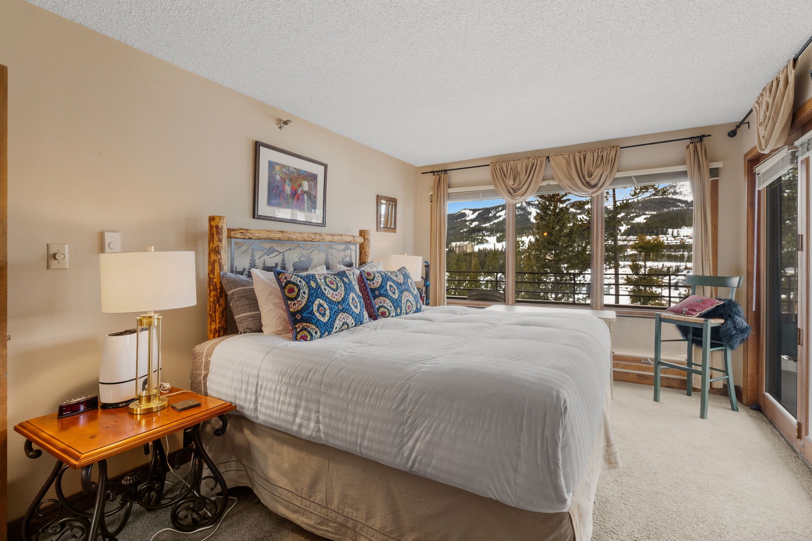 Wake up to stunning mountain views from your cozy bed, where rustic charm meets alpine elegance in this serene retreat.