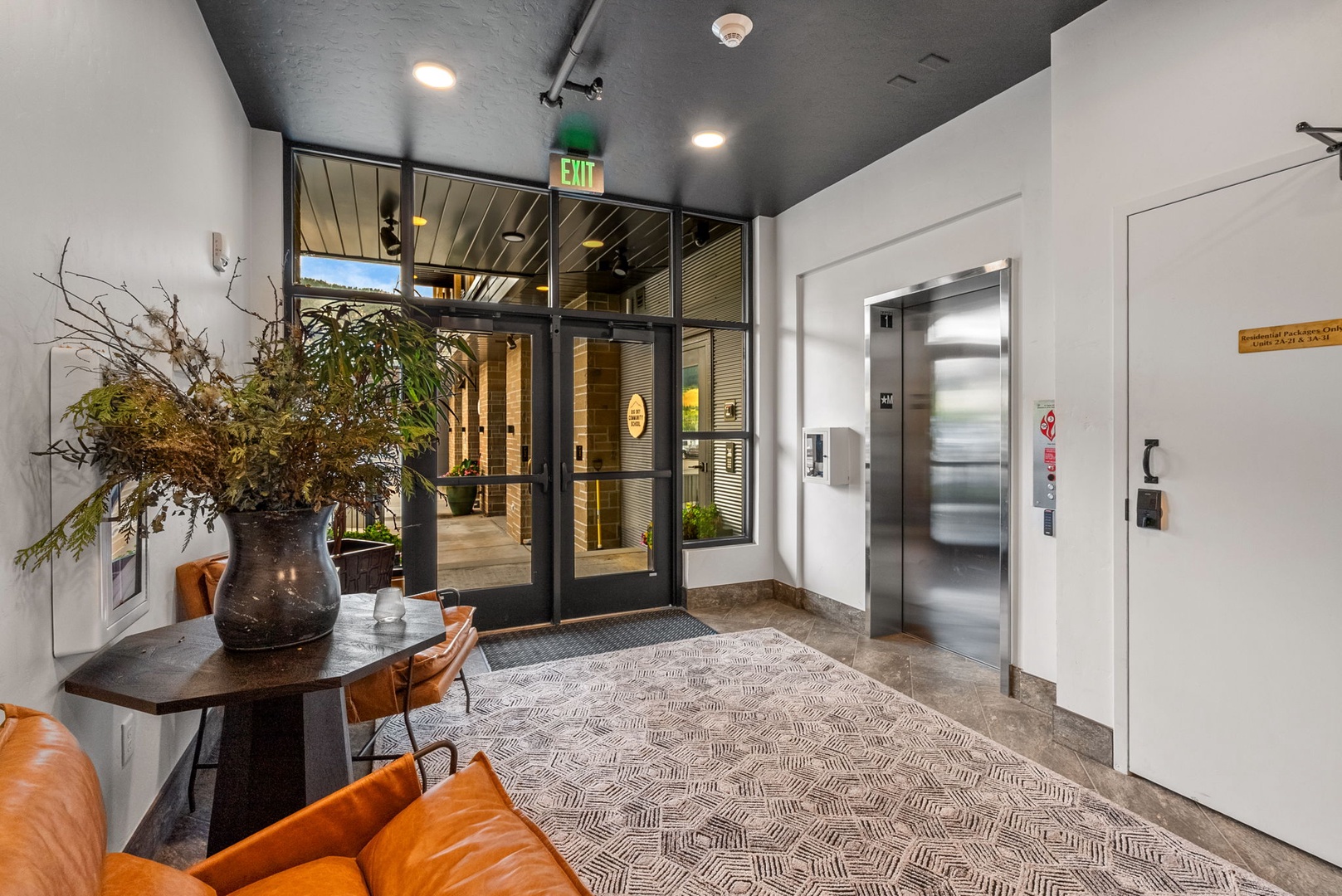 Step into a thoughtfully designed lobby where modern comfort meets urban sophistication. Rich leather seating and botanical touches create a warm first impression, while sleek glass doors frame your arrival experience.