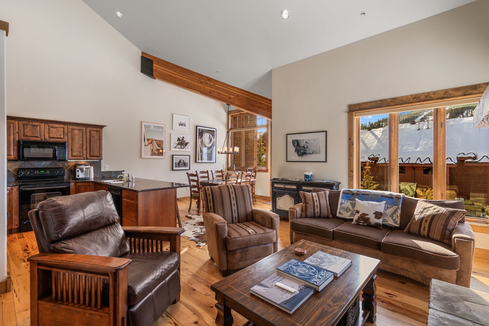 Unwind in your spacious open-concept retreat, where rich leather seating and warm wood accents create the perfect mountain escape.