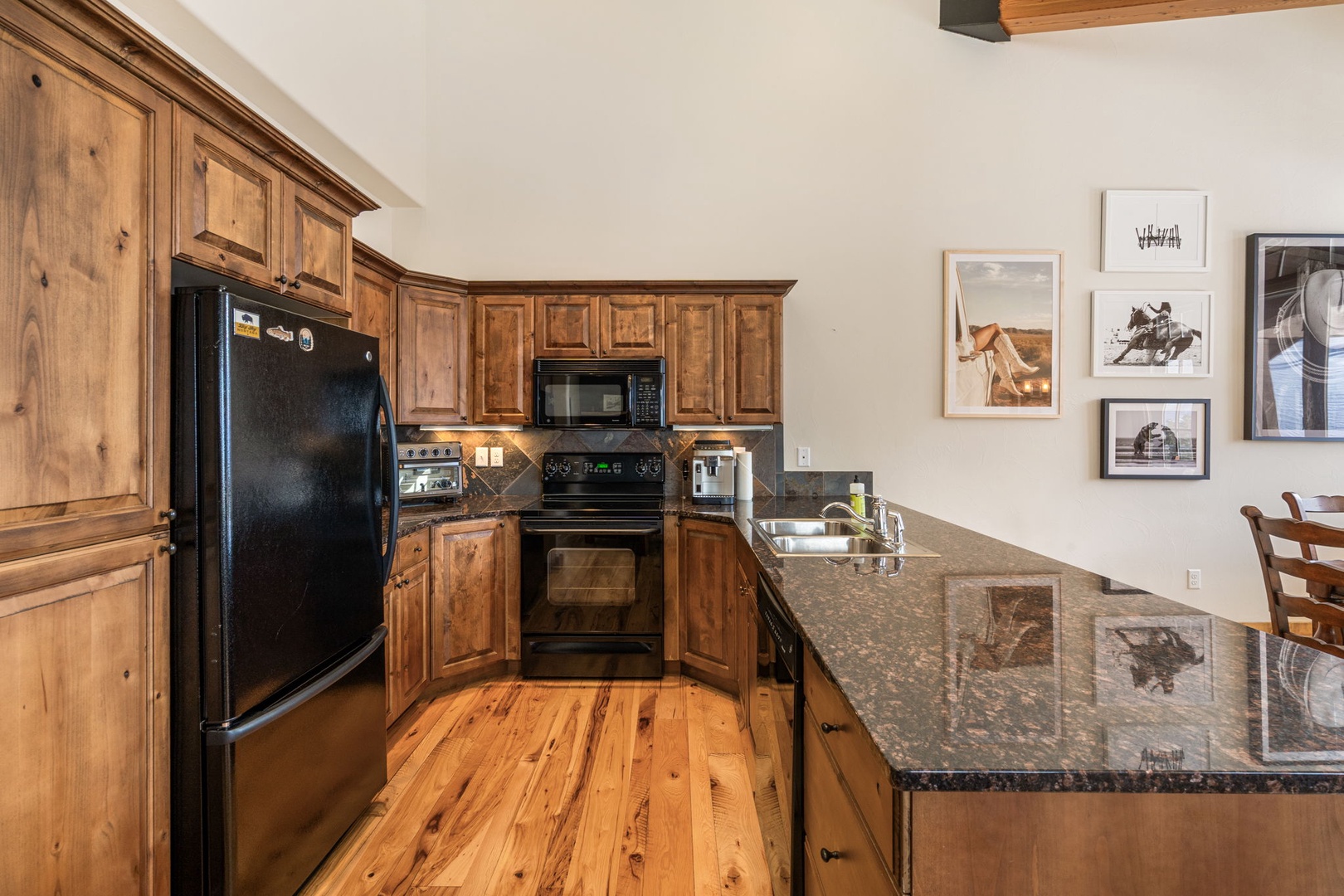Your fully equipped kitchen features warm wood cabinets, granite counters, and modern appliances for memorable home-cooked meals.