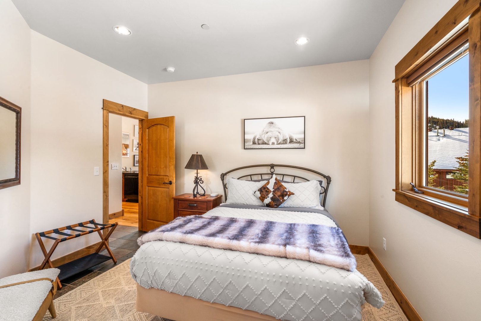 Wake up to breathtaking mountain views through your bedroom window, where crisp linens and warm wood accents create your perfect alpine retreat.