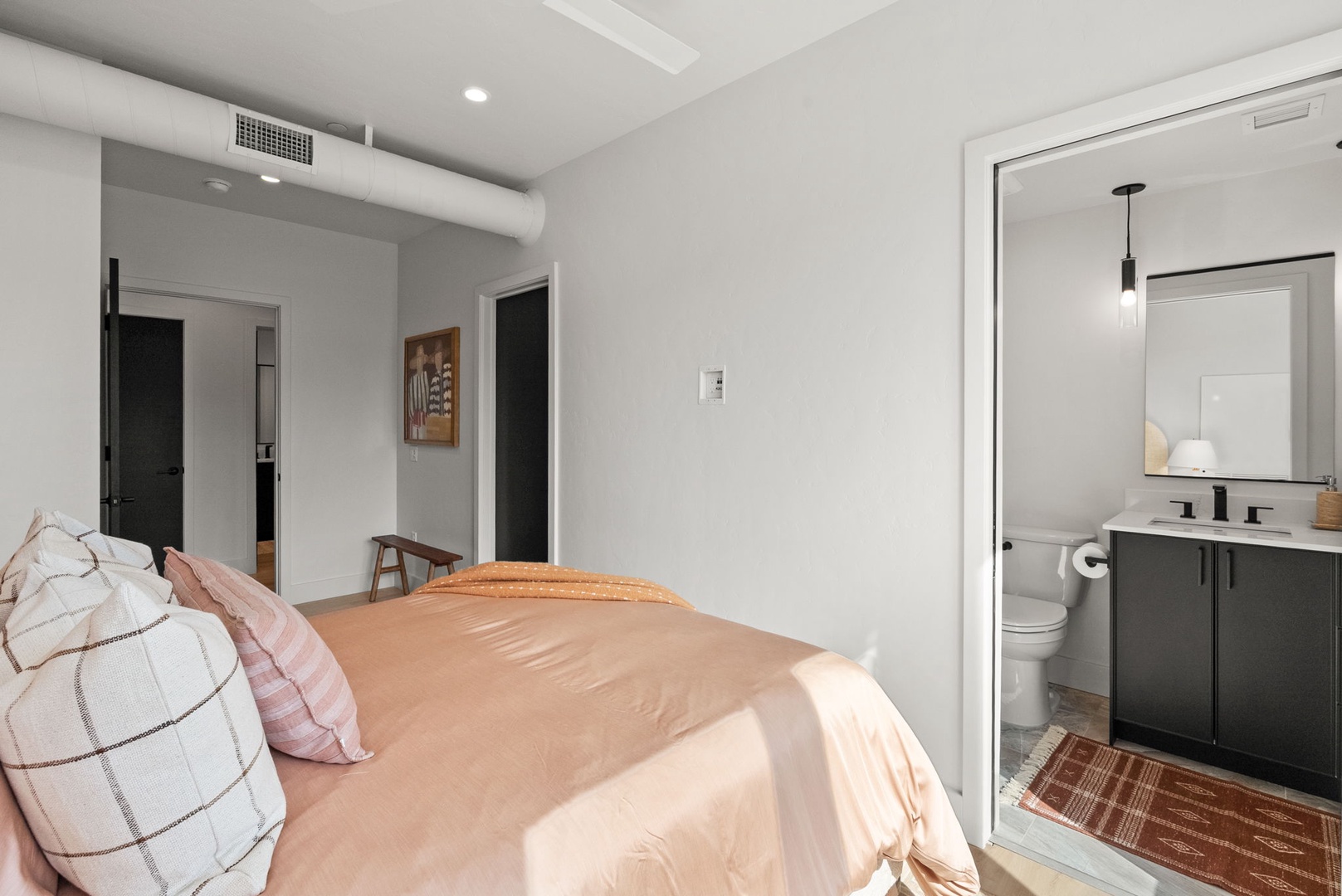 Sink into soft linens and unwind in your peaceful retreat, where modern design meets calming comfort. Your private en-suite awaits just steps away, making your stay effortless.