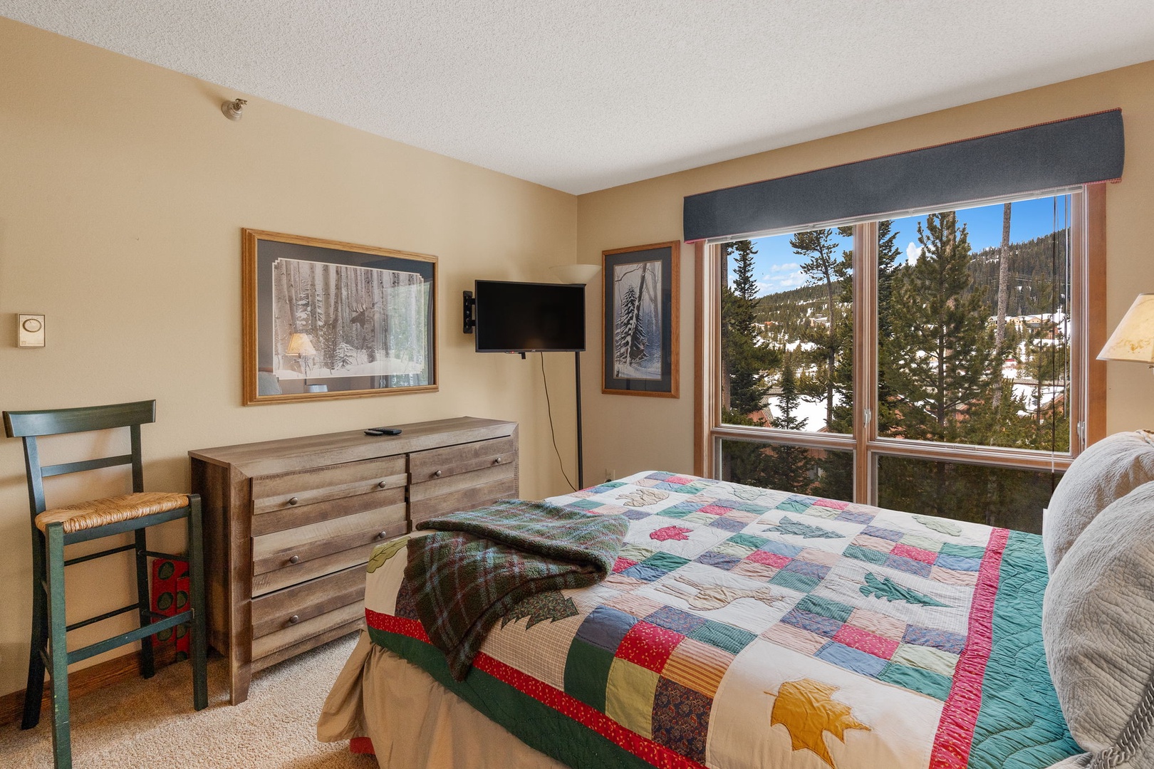 Wake up to stunning mountain views through your bedroom window, where snowy peaks and evergreen forests create a peaceful backdrop for your mountain retreat.