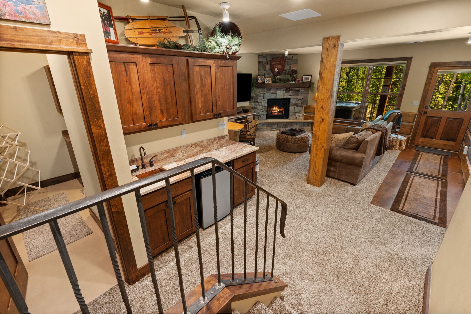 Unwind in this inviting open-concept space where rustic wood beams meet modern comfort. Cozy up by the stone fireplace or step onto your private hot tub deck surrounded by nature.