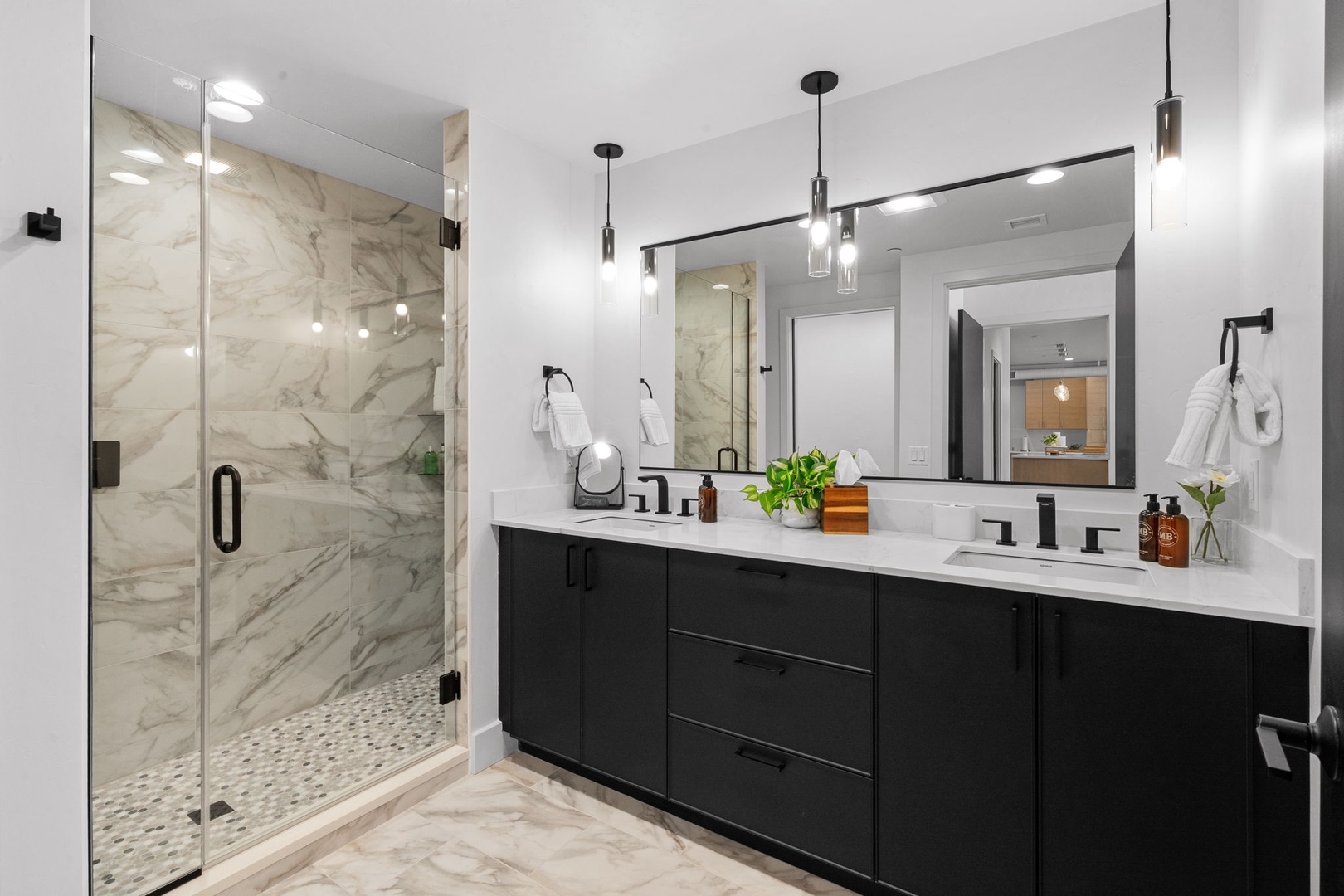 Step into your luxurious marble sanctuary with a stunning glass shower and elegant double vanity for your daily rituals.