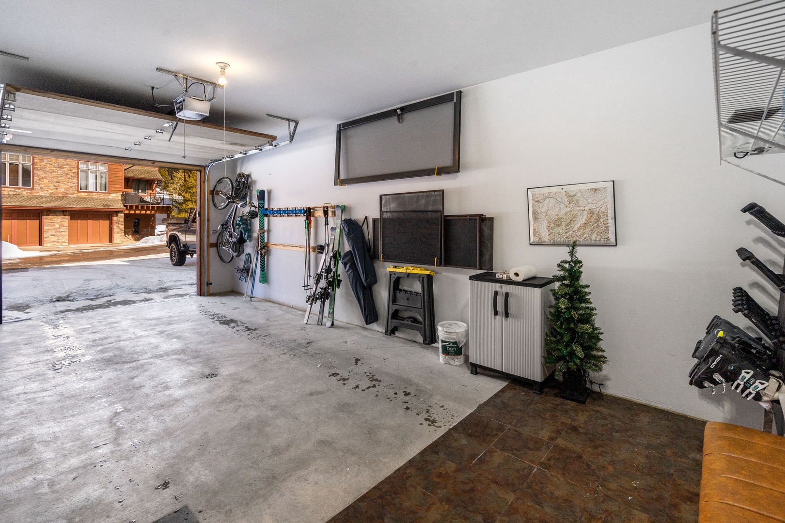 Secure garage with organized storage and entertainment setup for your convenience and relaxation.