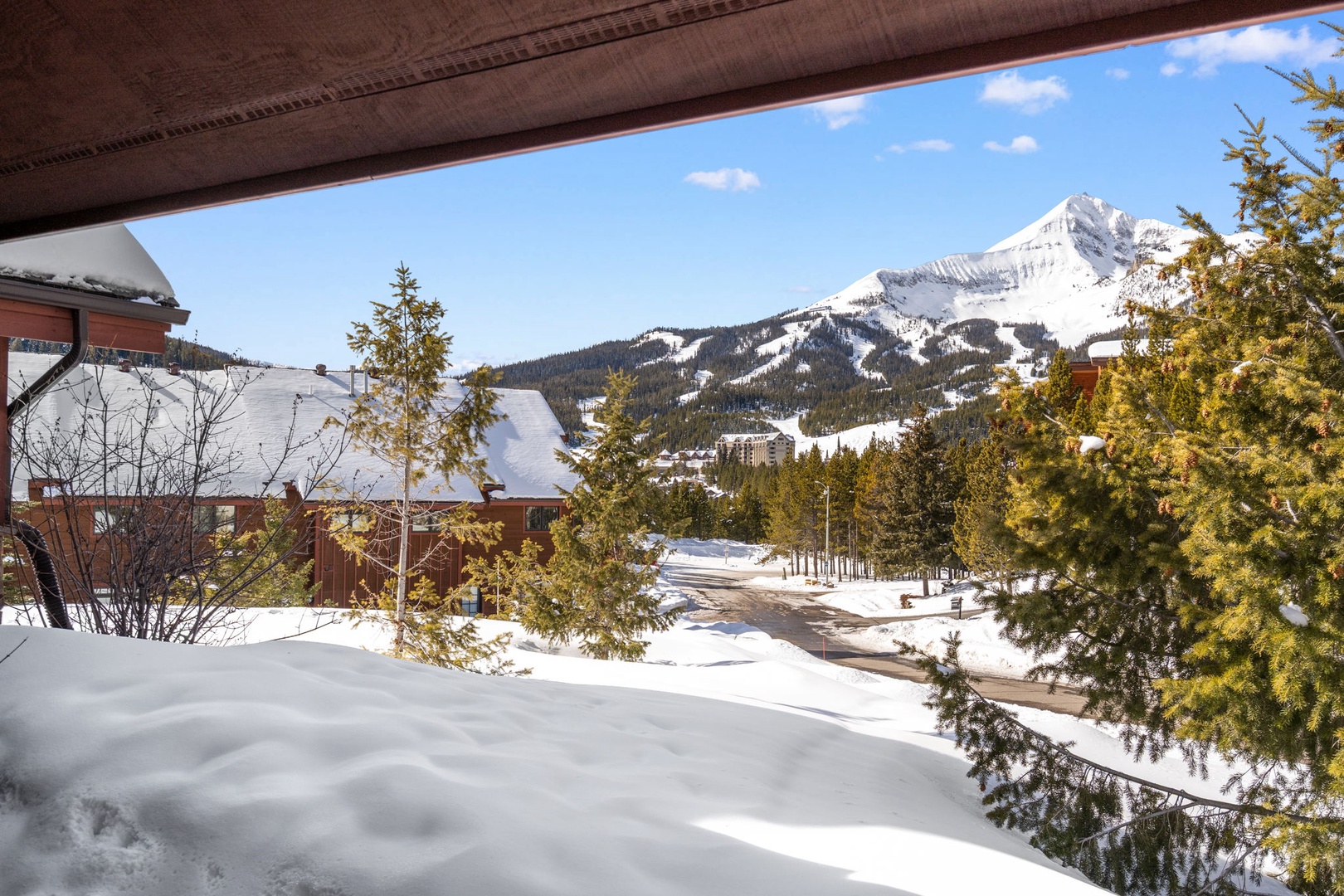 Stunning mountain vistas frame this winter wonderland, where snow-capped peaks create a dramatic backdrop for the cozy alpine village below.