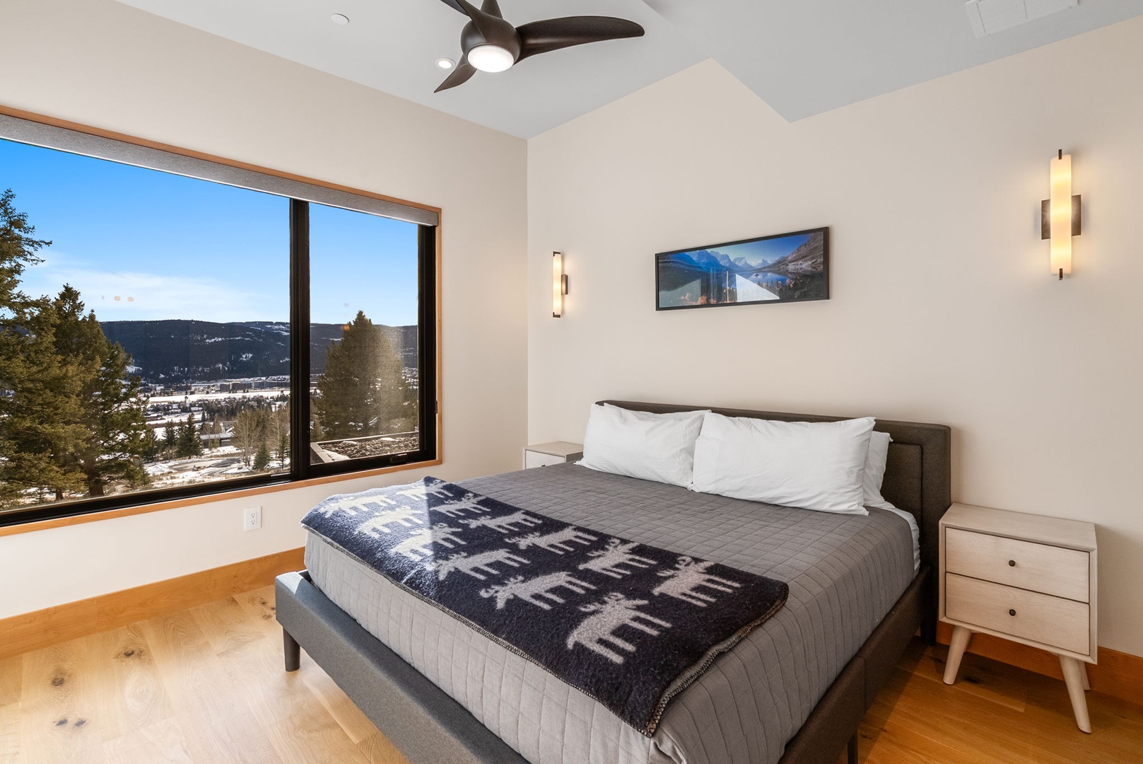 Wake up to stunning mountain views from your cozy bedroom, where modern comfort meets alpine charm through expansive windows.