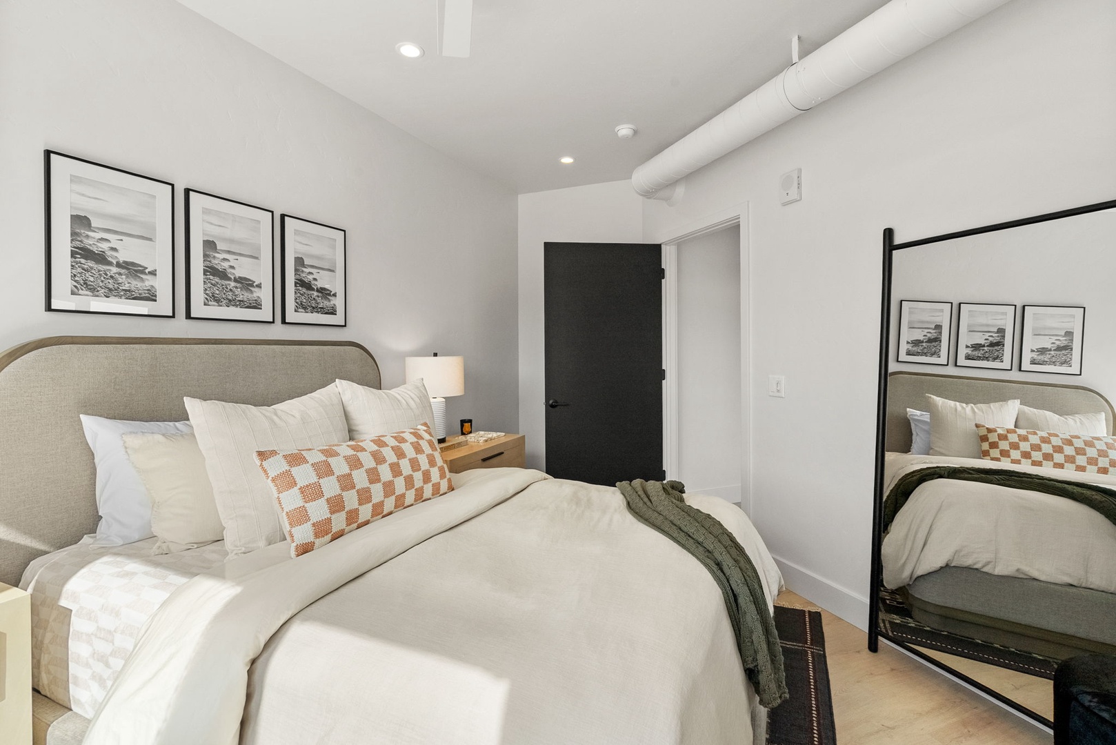 Sink into plush bedding and enjoy the calming coastal artwork that frames your restful retreat.