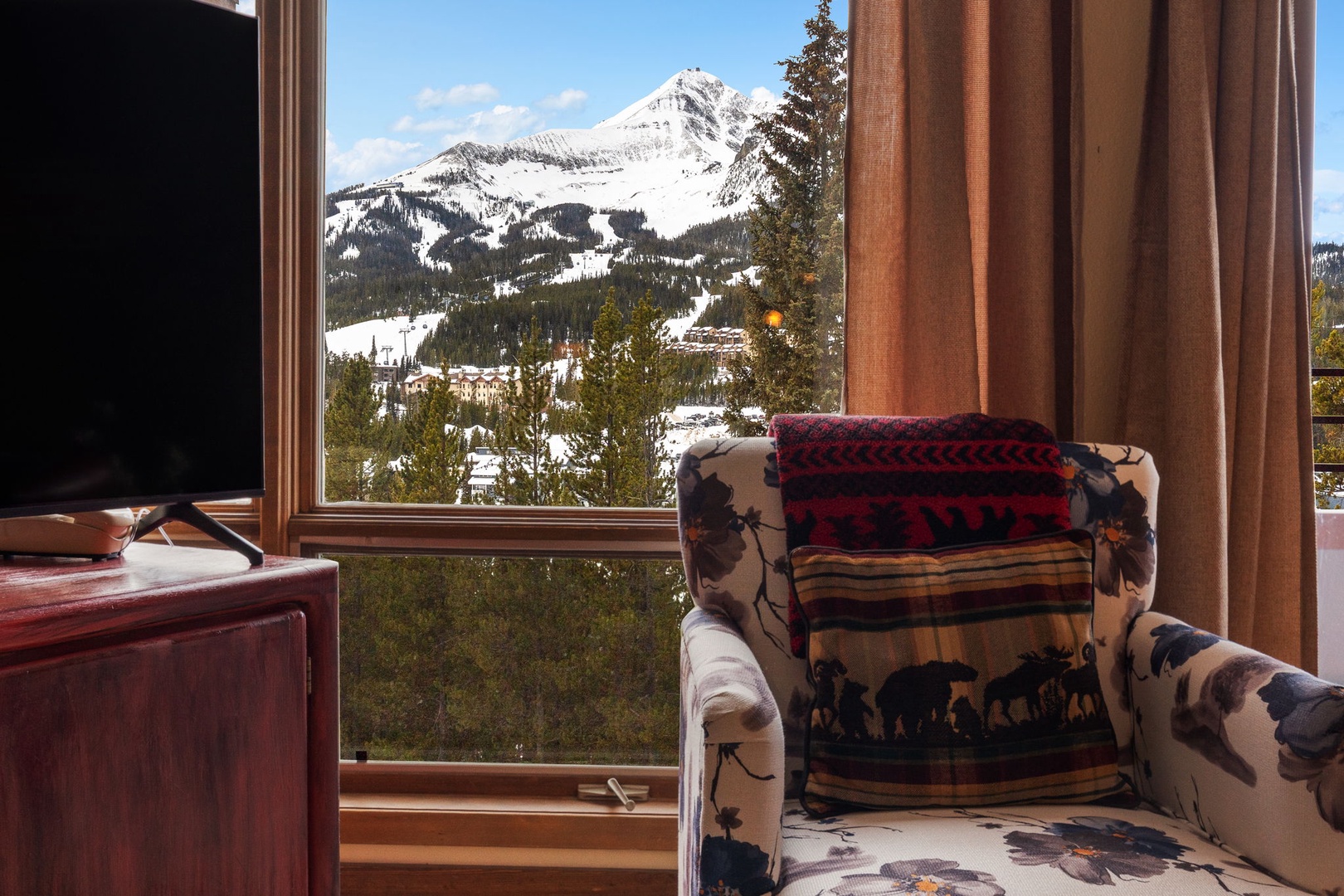 Breathtaking mountain panoramas frame your cozy reading nook, where snow-capped peaks create the perfect backdrop for morning coffee moments.