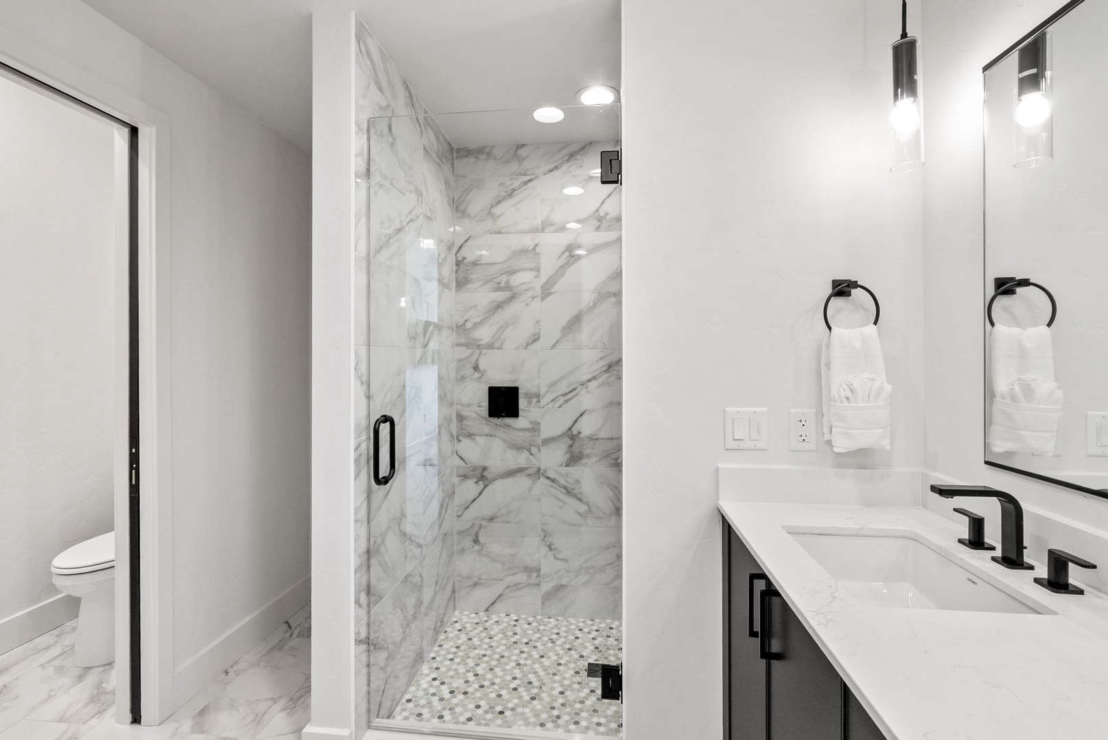 Sleek marble finishes and modern fixtures create your private spa-like retreat. The walk-in shower and dual vanity offer comfort and convenience for refreshing mornings.