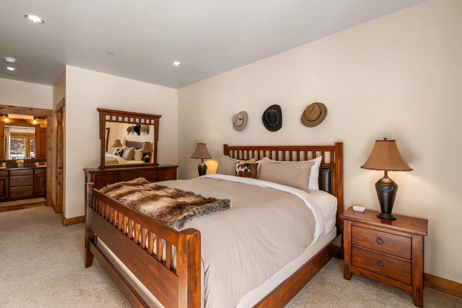 Sink into this cozy bedroom where rustic charm meets comfort. Your plush bed awaits with soft linens and western-inspired decor.