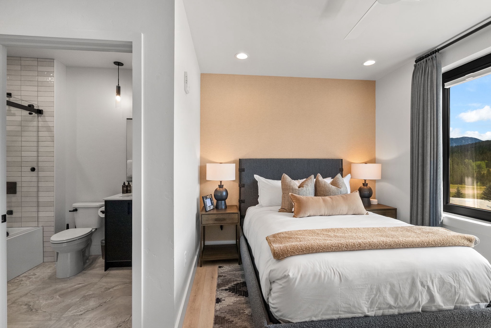 Unwind in your serene retreat with crisp linens, warm tones, and a tranquil mountain view. Step into your private spa-like ensuite to refresh after a day of adventure.