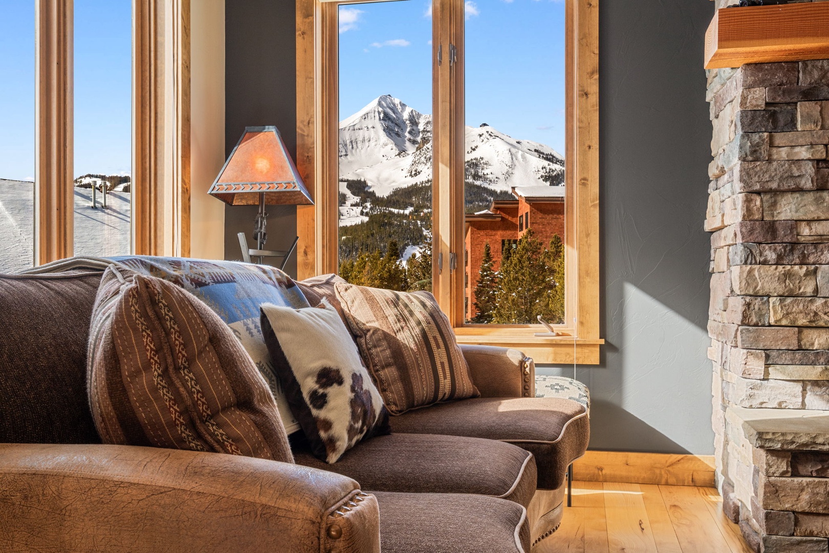 Sink into plush seating while snow-capped peaks frame your mountain getaway through expansive windows.