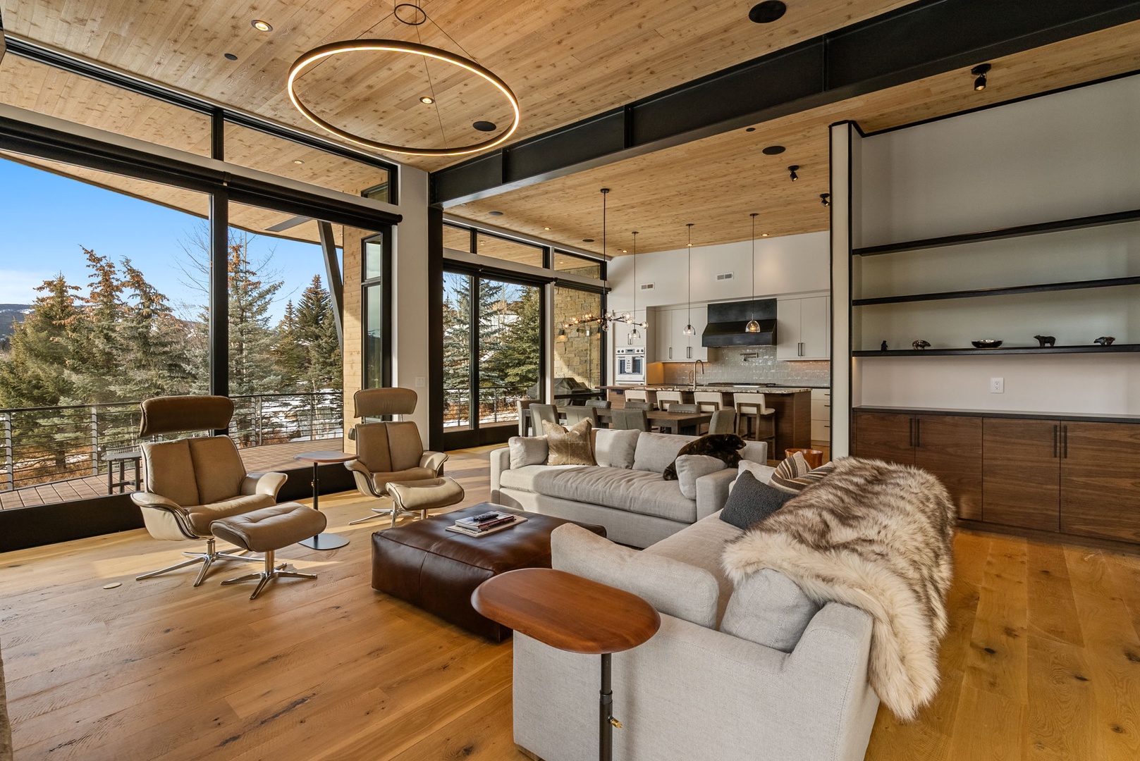 Relax in this stunning open-plan sanctuary where floor-to-ceiling windows frame mountain views, plush seating invites conversation, and modern kitchen awaits your culinary adventures.