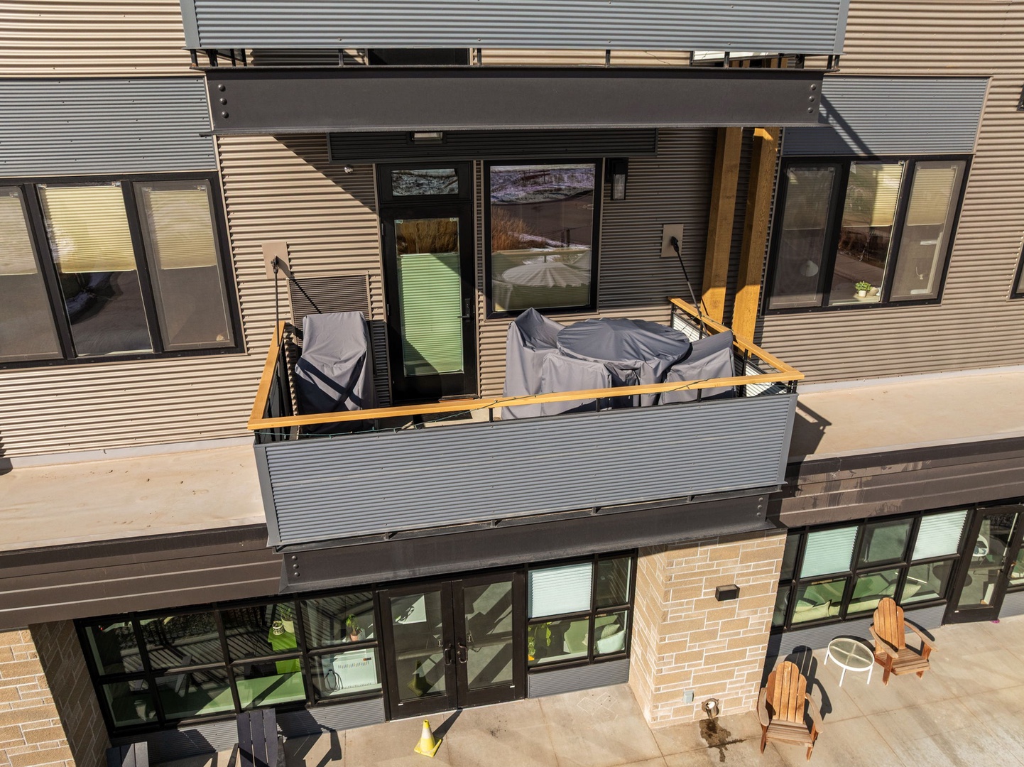 Modern property exterior showcasing contemporary architecture with covered furniture and outdoor seating areas ready for your arrival.