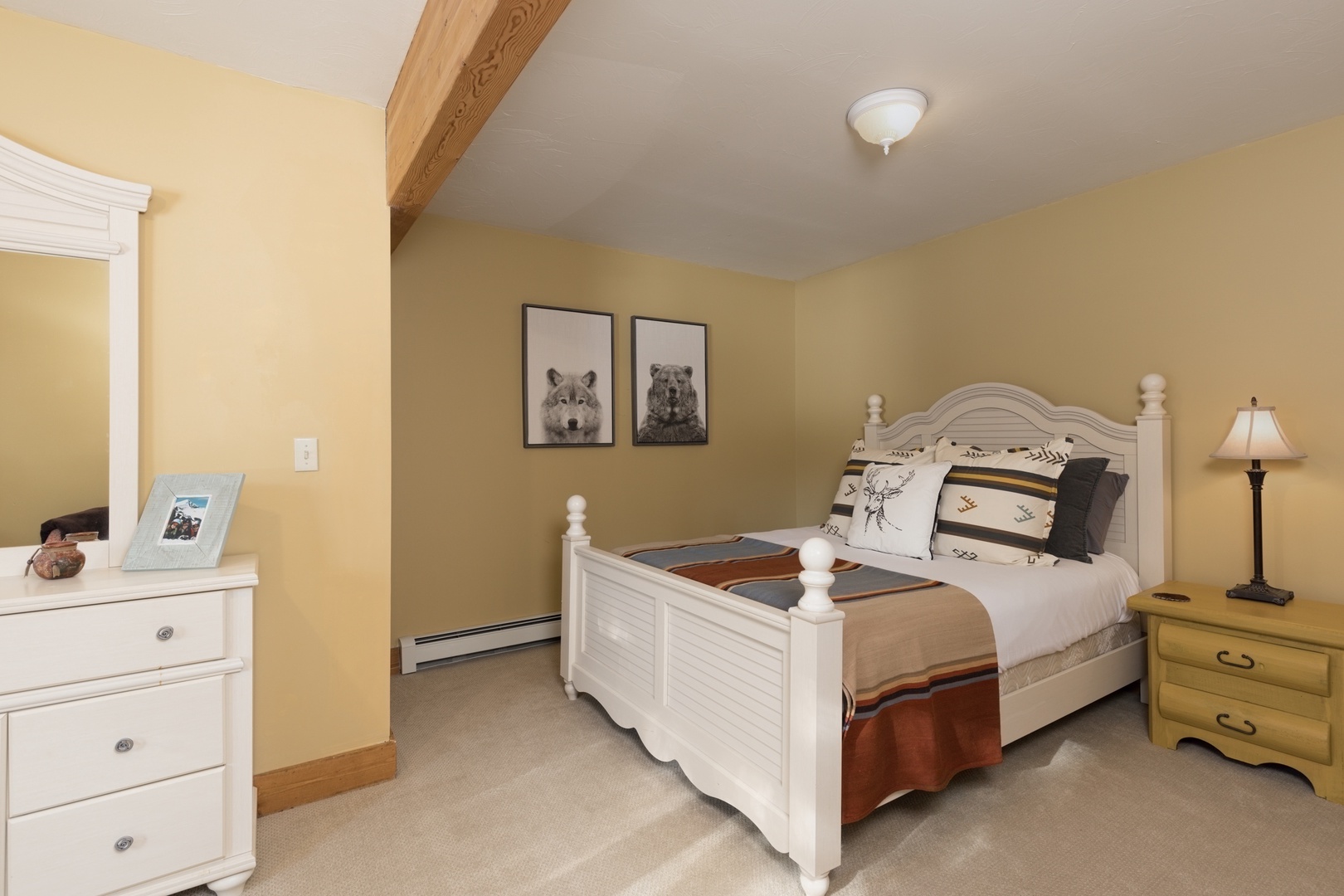 Unwind in your cozy bedroom featuring warm colors and rustic wooden beams that create the perfect retreat for peaceful nights.