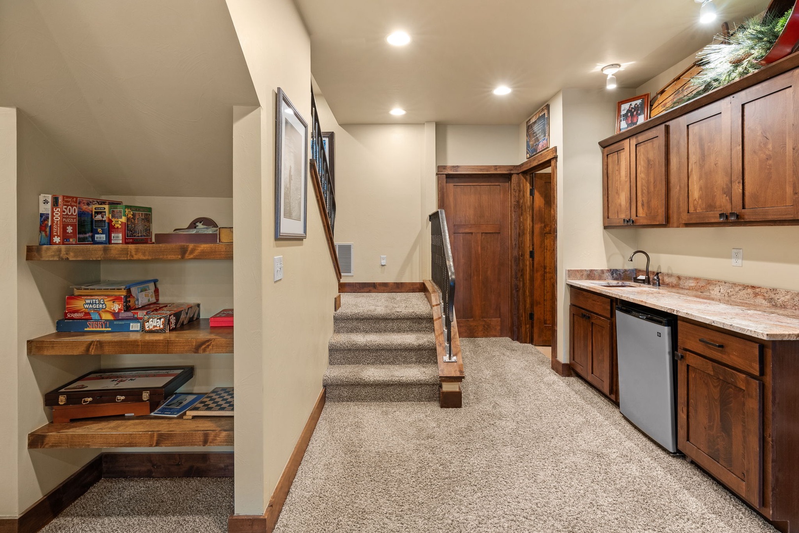 You'll find everything you need in this cozy entertainment area with a kitchenette, stocked game shelves, and easy access to your space—perfect for relaxing after mountain adventures.