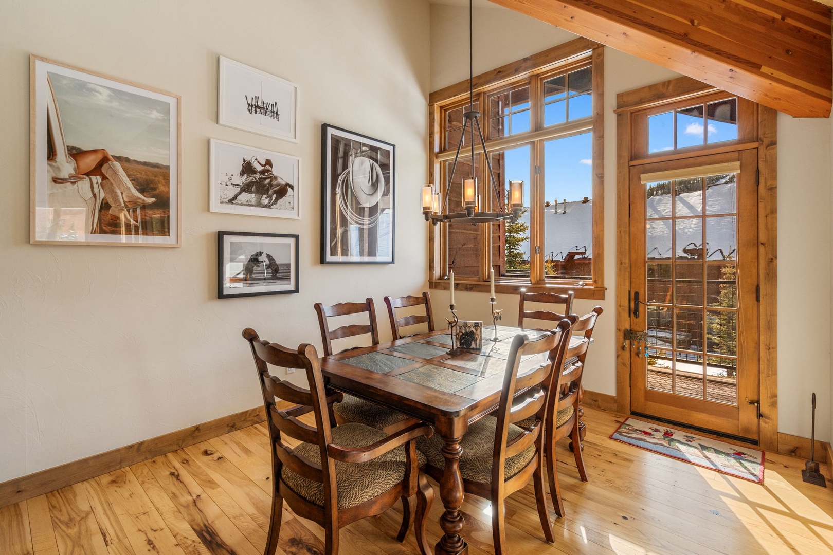 Gather around your rustic dining table where warm wood tones and charming artwork create the perfect setting for memorable meals together.