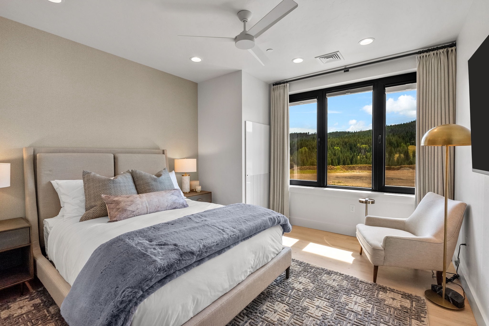 Sink into luxurious bedding and wake to stunning mountain views through oversized windows. Your private retreat features modern comfort, elegant furnishings, and natural light that fills every corner with warmth.