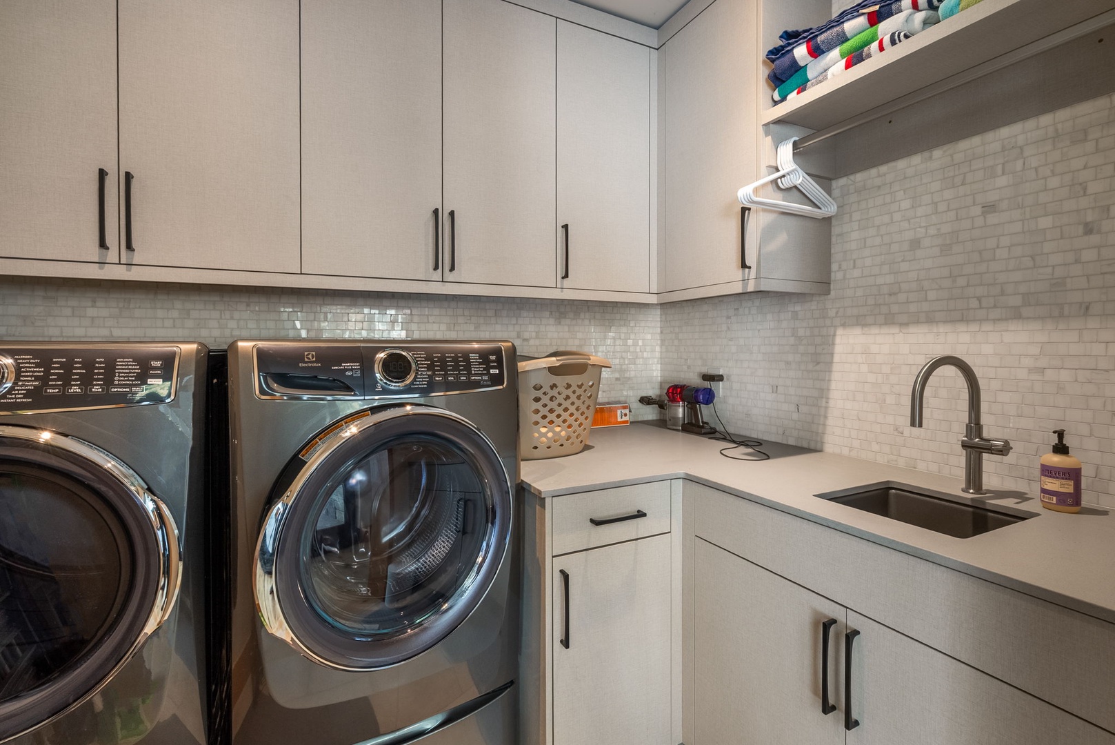 Your dedicated laundry room features modern appliances, ample storage, and a convenient sink for all your washing needs.