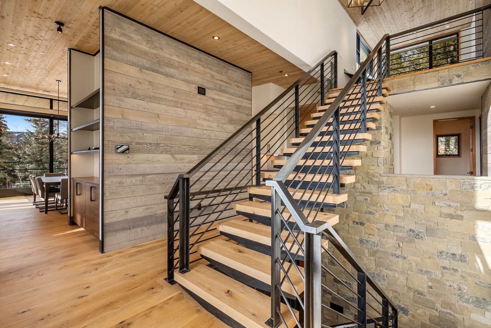 Step into your mountain retreat where warm wood meets modern design. Natural stone walls and soaring ceilings create an inviting atmosphere perfect for relaxation.