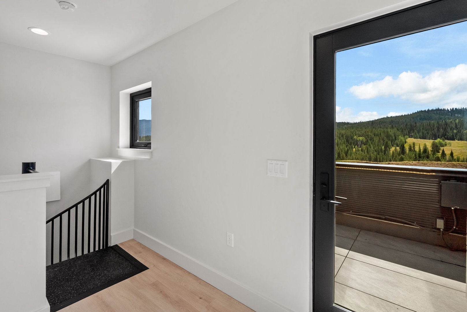 Step outside to your private terrace and breathe in sweeping mountain vistas framed by evergreen forests—a peaceful retreat waiting just beyond your door.