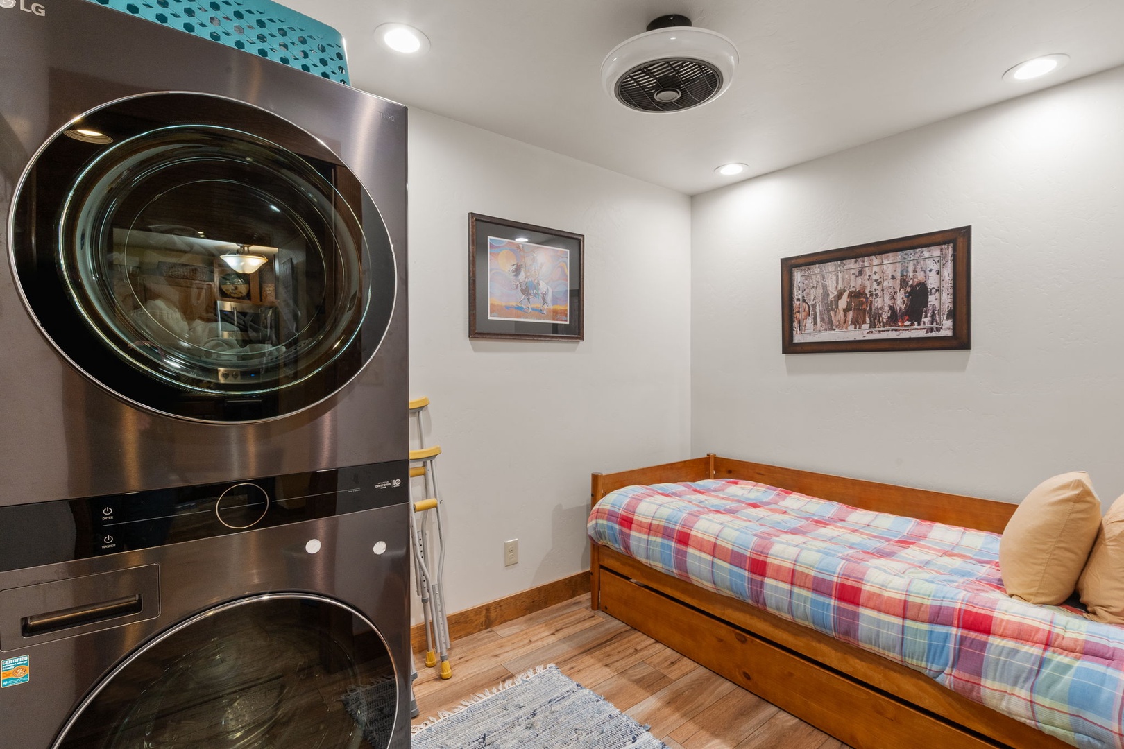 Your private laundry room features modern appliances and a cozy daybed for relaxation while clothes wash.