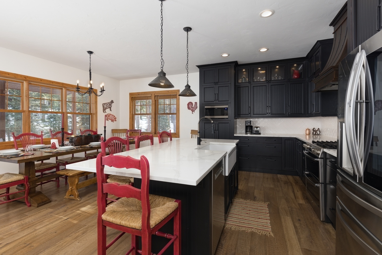 Your spacious kitchen features dark cabinetry, white counters, and red dining chairs where you'll create memorable meals together.