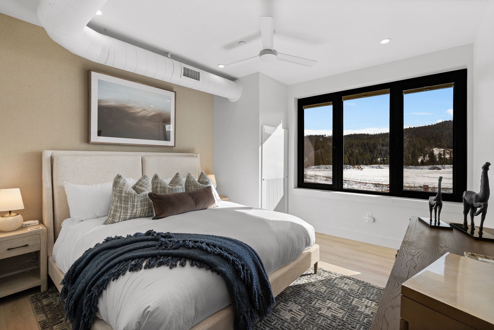 Wake up to stunning mountain vistas from your luxurious bedroom, where crisp linens and modern comfort create the perfect alpine retreat.