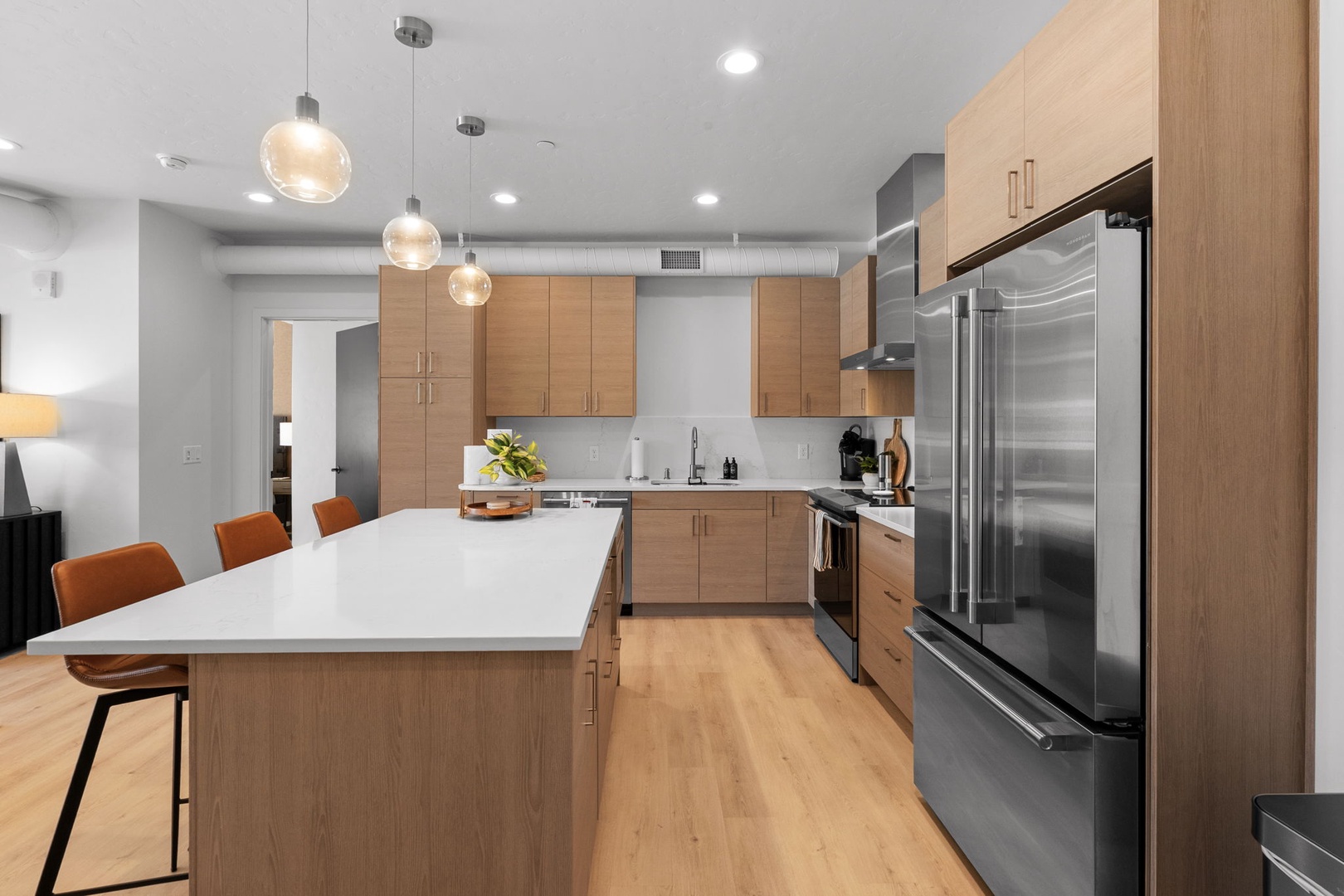 Your modern kitchen invites culinary creativity with sleek cabinets, stainless steel appliances, and a spacious island for gathering.