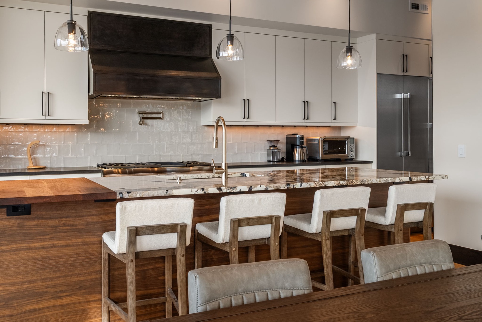 Your gourmet kitchen awaits with granite counters, premium appliances, and a spacious island perfect for cooking together.