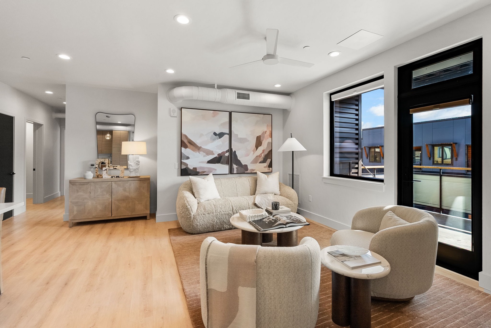 Sink into plush seating and unwind in your bright, modern living space, where neutral tones and natural light create the perfect retreat after exploring.