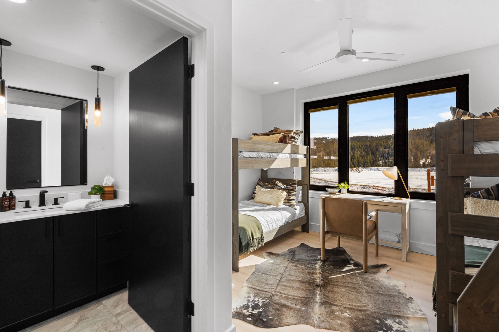 Cozy bunk beds with mountain views through large windows create your perfect retreat after adventurous days.